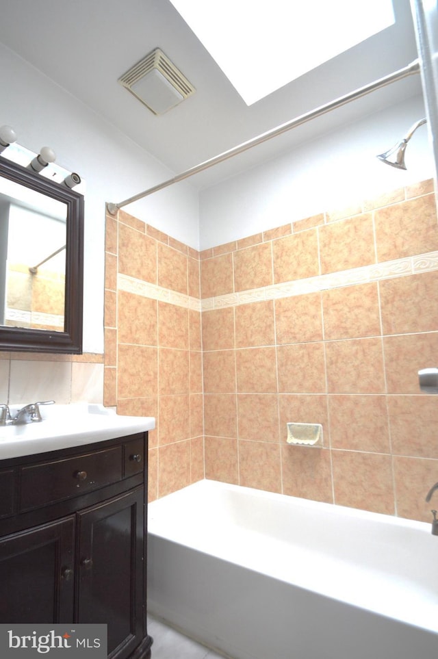 bathroom featuring vanity, tasteful backsplash, tub / shower combination, and visible vents