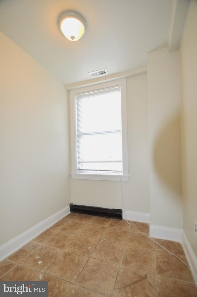 spare room featuring visible vents, baseboards, and light tile patterned flooring