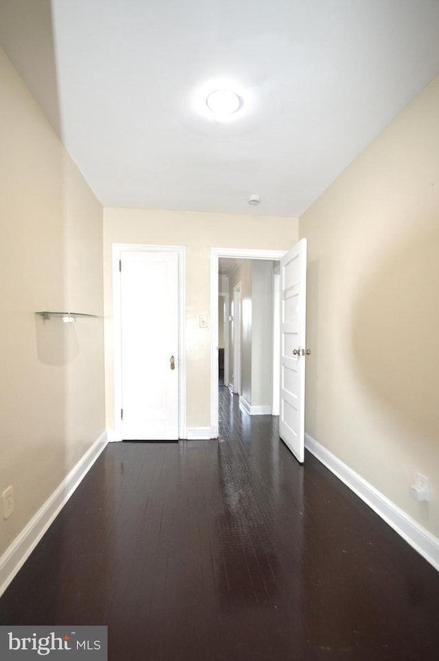 unfurnished bedroom featuring baseboards and wood finished floors