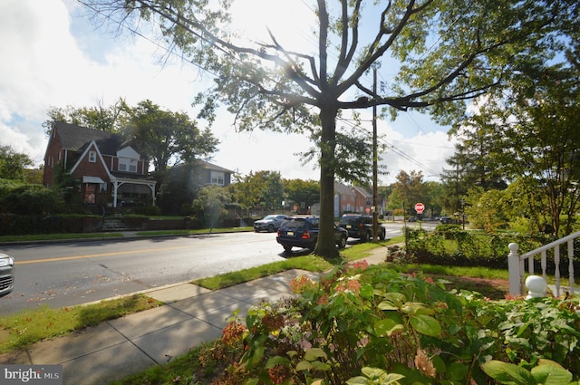 view of road with curbs, traffic signs, and sidewalks