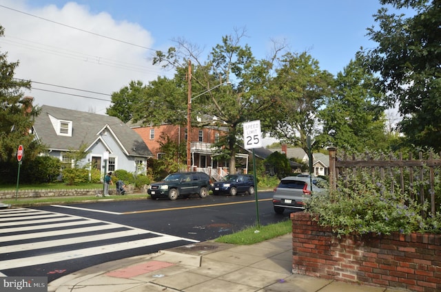 view of street with traffic signs, street lighting, and sidewalks