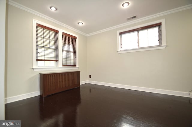 spare room featuring baseboards, a wealth of natural light, and ornamental molding