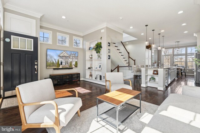 living area with dark wood-style floors, stairway, recessed lighting, and crown molding