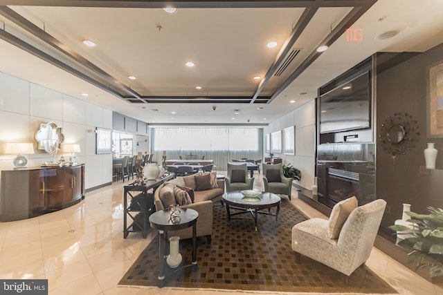 living room featuring a tray ceiling, recessed lighting, visible vents, and tile patterned floors