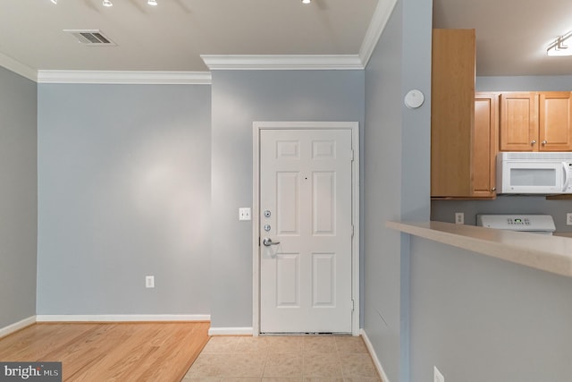 foyer entrance featuring light tile patterned floors, visible vents, baseboards, and crown molding