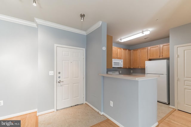 kitchen with white appliances, baseboards, a peninsula, ornamental molding, and light countertops