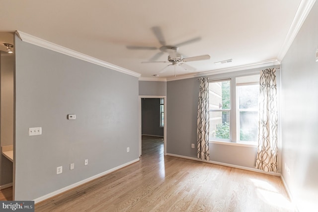 unfurnished room featuring visible vents, wood finished floors, a ceiling fan, and crown molding