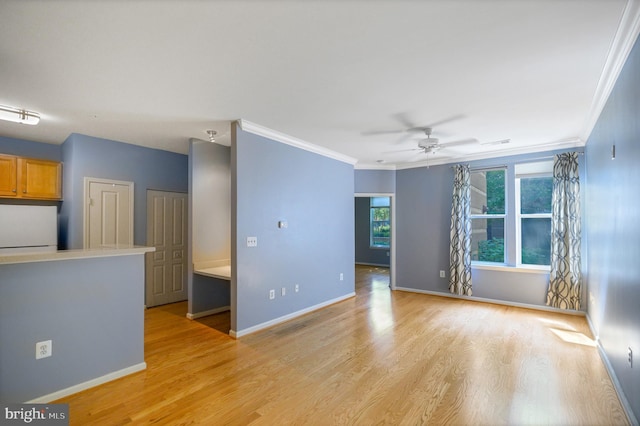 unfurnished living room with visible vents, baseboards, ceiling fan, ornamental molding, and light wood-style flooring