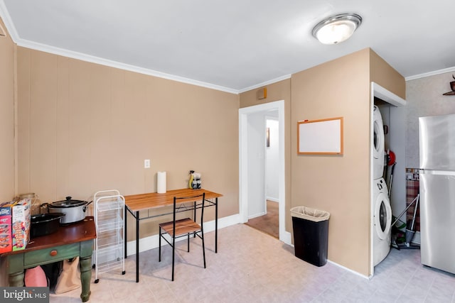 office with stacked washing maching and dryer, tile patterned floors, crown molding, and baseboards