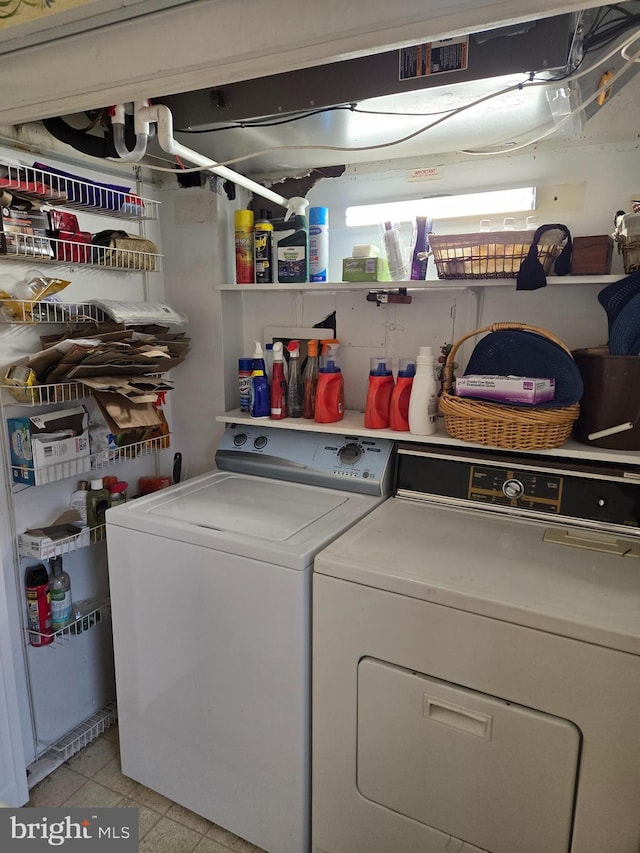 laundry room with light tile patterned floors, laundry area, and independent washer and dryer