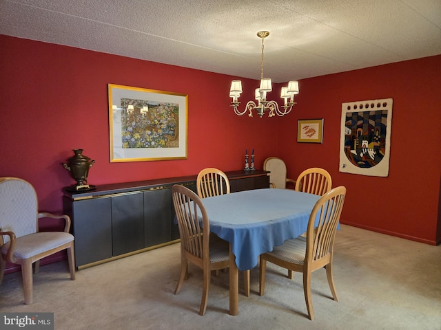 carpeted dining area with a notable chandelier, a textured ceiling, and baseboards