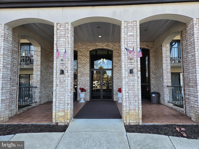 doorway to property with brick siding and french doors