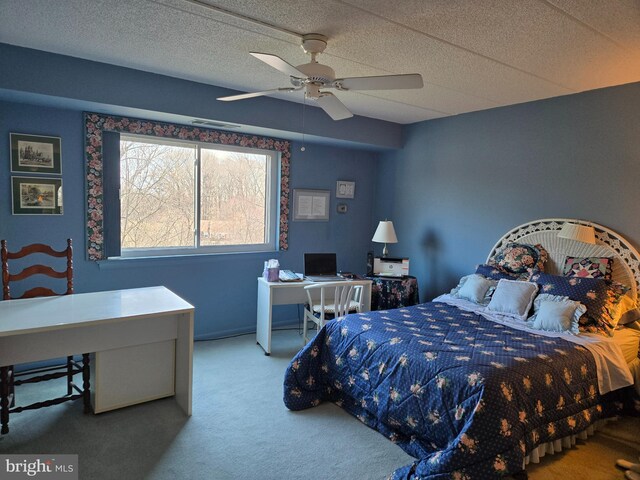 carpeted bedroom with visible vents and a ceiling fan