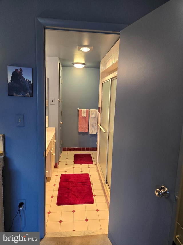 bathroom with a stall shower and vanity