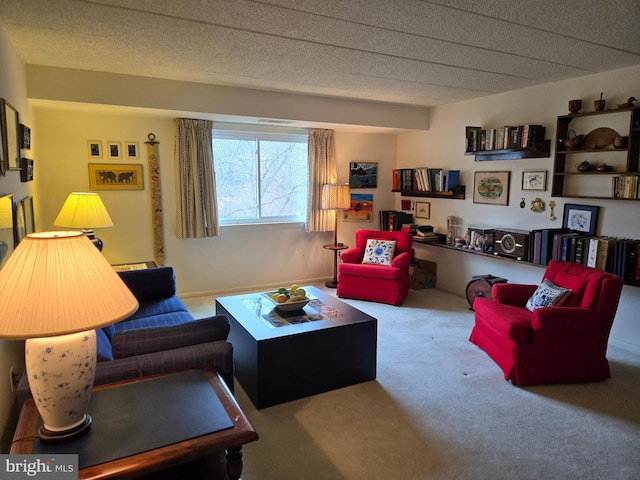 living area featuring carpet flooring and a textured ceiling