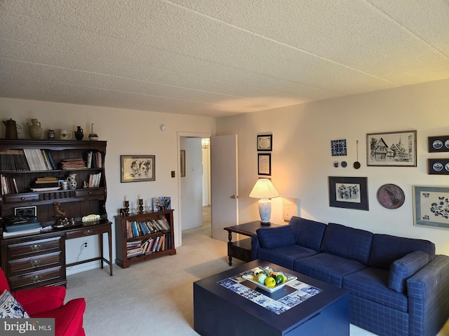 carpeted living area featuring a textured ceiling