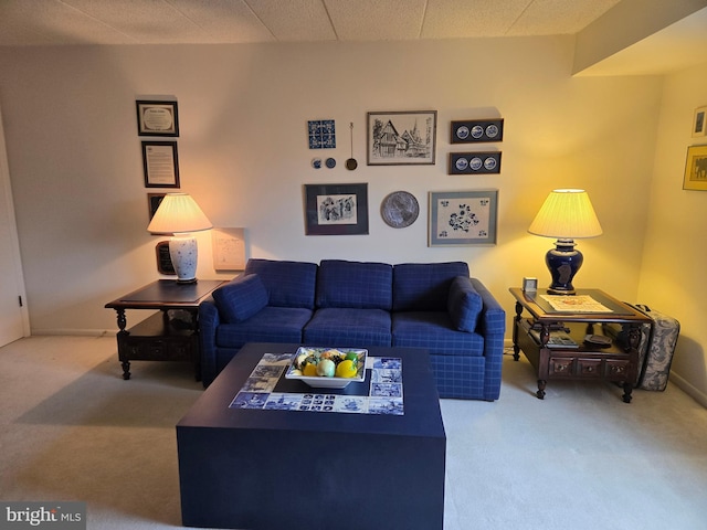 carpeted living area with baseboards