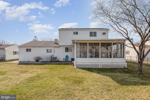 rear view of property with a lawn, cooling unit, fence, and a sunroom