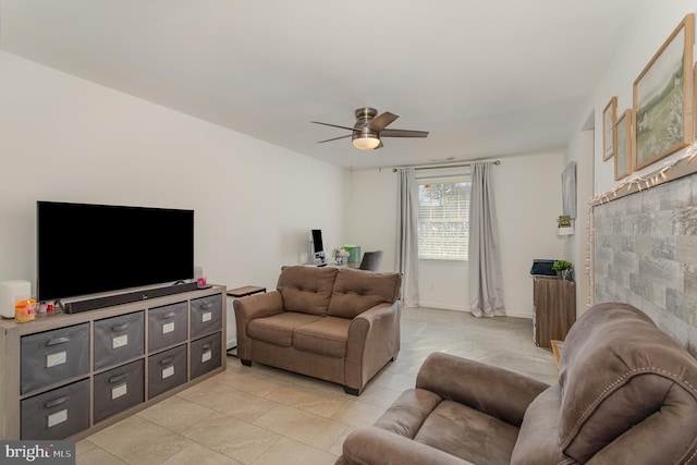 living room featuring light tile patterned flooring, a ceiling fan, and baseboards