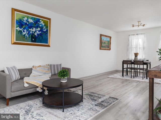 living area with baseboards and wood finished floors