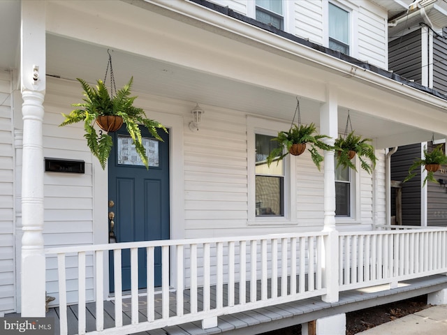 view of exterior entry with a porch