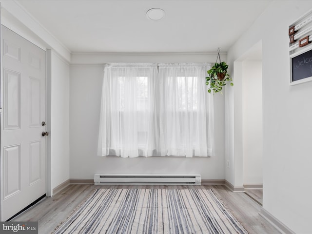 entrance foyer with wood finished floors, baseboards, and a baseboard radiator