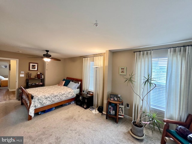 bedroom with a ceiling fan, carpet, and baseboards