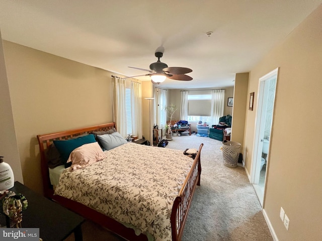 bedroom featuring a ceiling fan, baseboards, and light carpet