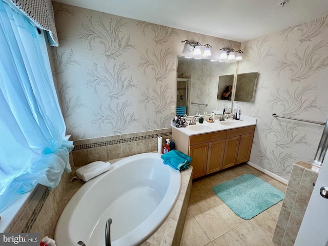 bathroom with wallpapered walls, a garden tub, and a sink