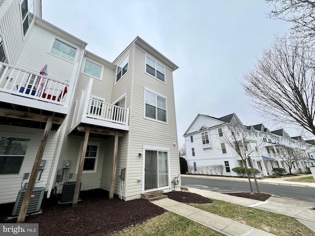 rear view of property with central AC