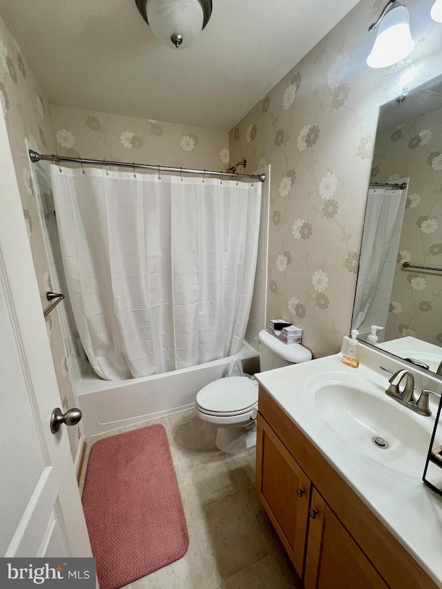 bathroom with toilet, shower / bath combo, vanity, and wallpapered walls