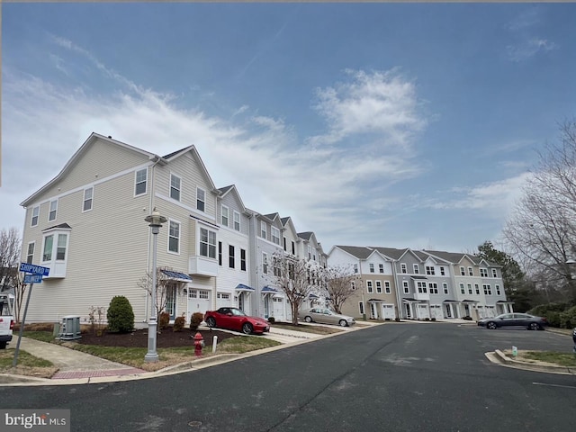 view of street with a residential view and curbs