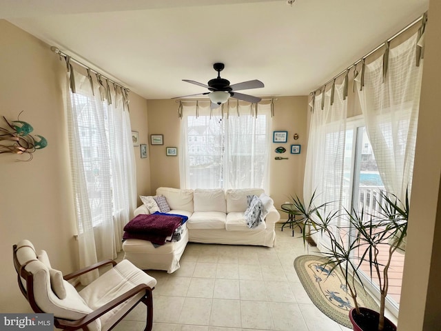 living room featuring a healthy amount of sunlight, light tile patterned flooring, and a ceiling fan