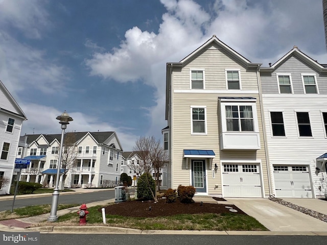 322 Shipyard Dr Unit 82, Cambridge, MD 21613 - view of property featuring concrete driveway, a garage, and a residential view