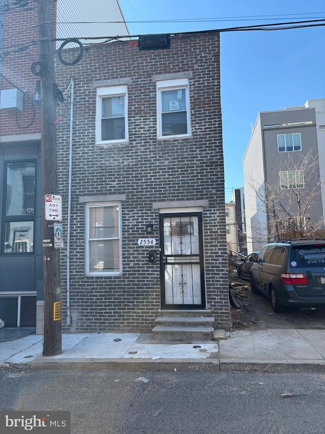 view of property featuring brick siding