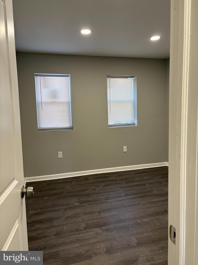 unfurnished room featuring recessed lighting, baseboards, and dark wood-style flooring