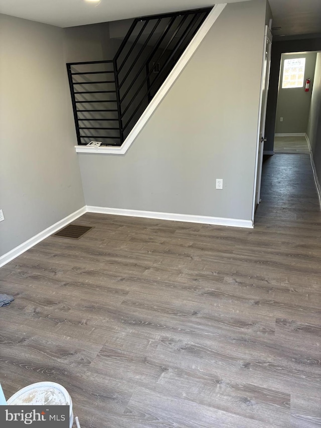 unfurnished room with visible vents, baseboards, and wood finished floors