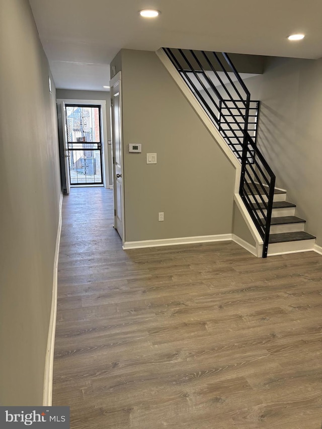 interior space with recessed lighting, baseboards, and wood finished floors