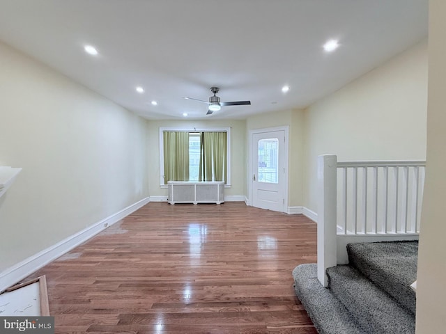 interior space with baseboards, stairway, recessed lighting, wood finished floors, and a ceiling fan