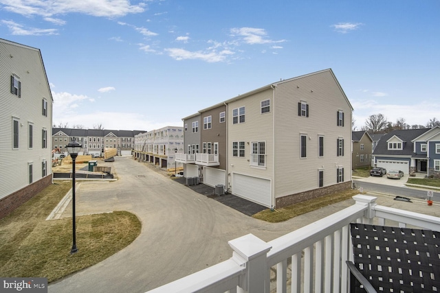 exterior space featuring central AC unit and a residential view