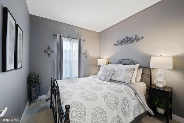 bedroom with baseboards and carpet