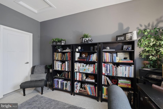 living area with carpet and attic access