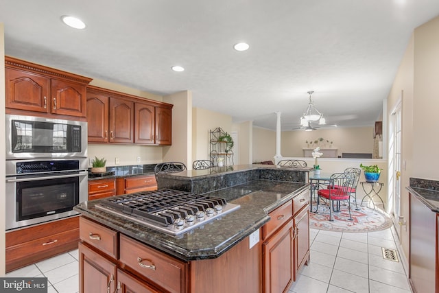kitchen featuring dark stone countertops, light tile patterned floors, recessed lighting, and stainless steel appliances