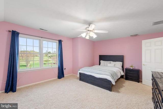 bedroom with carpet flooring, visible vents, and ceiling fan