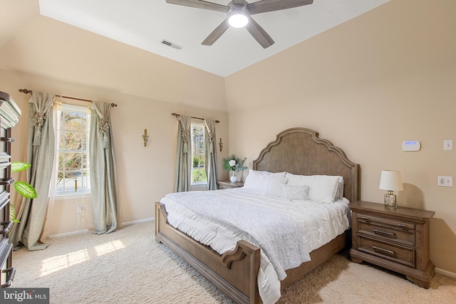 bedroom with visible vents, baseboards, a ceiling fan, vaulted ceiling, and light colored carpet