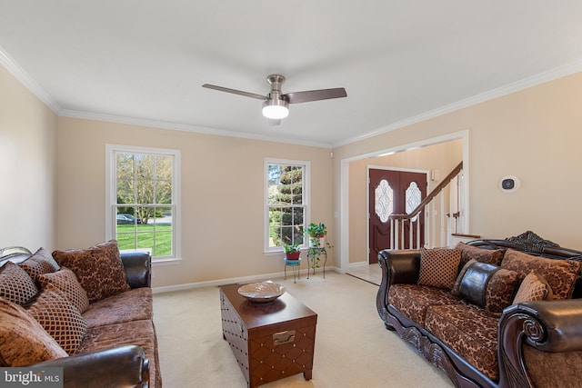 living room featuring ornamental molding, a ceiling fan, and light carpet
