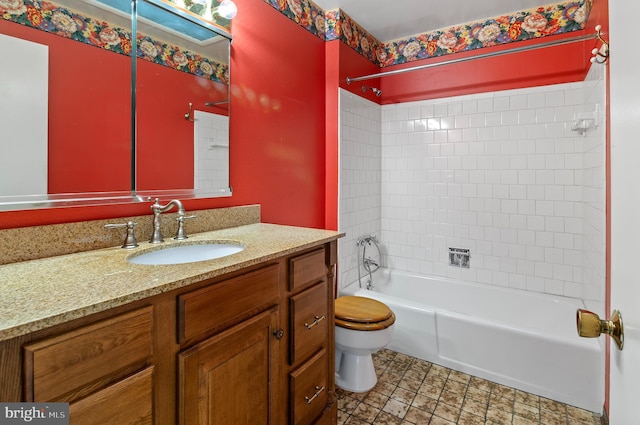 bathroom with toilet, vanity, and  shower combination