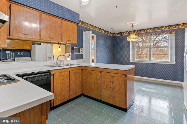 kitchen featuring a sink, wallpapered walls, black dishwasher, white fridge with ice dispenser, and light countertops