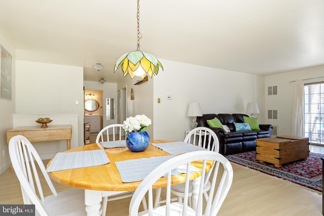 dining room with visible vents and light wood-style flooring