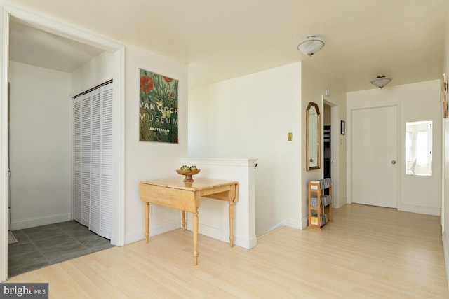 interior space with baseboards and wood finished floors